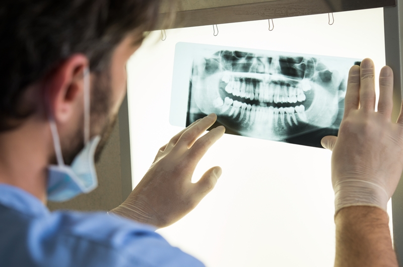 A dental x-ray can reveal problems that aren't visible to the naked eye. 