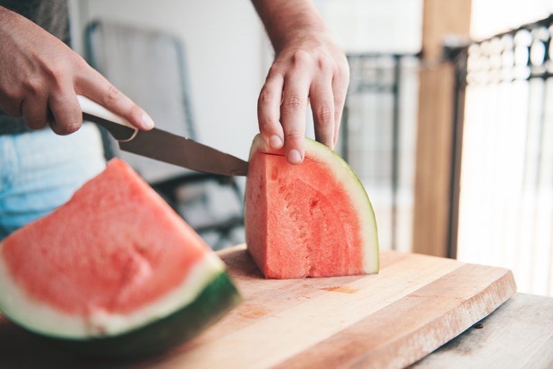 Man slicing watermelon