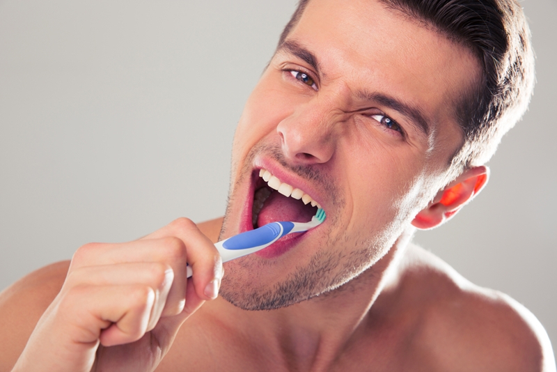man brushing teeth 